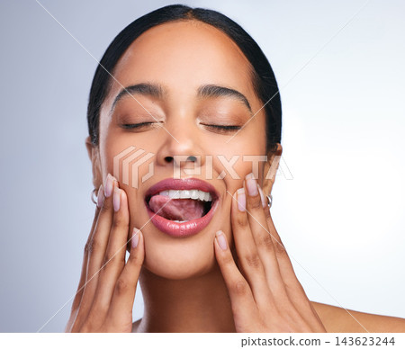 Woman, teeth and mouth with hands and smile for dental care, hygiene and oral health. Model girl, cosmetics and tongue or veneers for smile in studio with glow, wellness and results from cleaning Woman, teeth and mouth with hands and smile for dental care, hygiene and oral health. Model girl, cosmetics and tongue or veneers for smile in studio with glow, wellness and results from cleaning 143623244