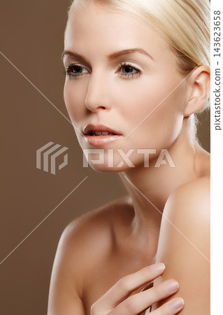 Woman, glow and skincare in studio for beauty, foundation and makeup treatment on brown background. Female person, dermatology and confidence for shine, smooth skin and facial wellness for cosmetics Woman, glow and skincare in studio for beauty, foundation and makeup treatment on brown background. Female person, dermatology and confidence for shine, smooth skin and facial wellness for cosmetics 143623658