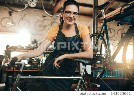 Woman, bicycle shop and portrait for maintenance job, startup with transport service. Bike, mechanic and female entrepreneur in workshop with glasses, happiness for sustainable business with apron Woman, bicycle shop and portrait for maintenance job, startup with transport service. Bike, mechanic and female entrepreneur in workshop with glasses, happiness for sustainable business with apron 143623661