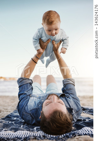 Beach, sand and dad with lifting baby on towel for summer vacation, bonding and child development. Family, adventure and man with infant by ocean for fathers day, love and outdoor holiday in Florida Beach, sand and dad with lifting baby on towel for summer vacation, bonding and child development. Family, adventure and man with infant by ocean for fathers day, love and outdoor holiday in Florida 143624176