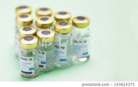 Medical, Covid vaccine and bottle in studio, emergency health care for pandemic. Green background, glass container and medicine with research for virus, chemistry development for human wellness Medical, Covid vaccine and bottle in studio, emergency health care for pandemic. Green background, glass container and medicine with research for virus, chemistry development for human wellness 143624375