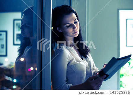 Woman, tablet and working in office and night, deadline for online and digital presentation in corporate company. Research, browsing for information in professional workspace, tired and overtime 143625886