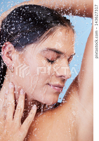 Shower, water and woman washing hair for shampoo, cosmetics and wellness cleaning or conditioner. Female person, happy and rinsing scalp in studio blue background for skin care or morning routine Shower, water and woman washing hair for shampoo, cosmetics and wellness cleaning or conditioner. Female person, happy and rinsing scalp in studio blue background for skin care or morning routine 143627317