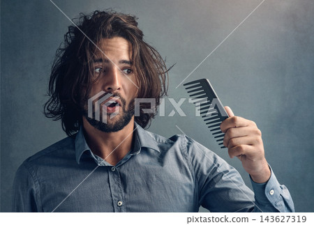 Man, studio and stress with comb for hair loss with aging isolated on grey background. Shock, surprise and anxiety with losing confidence or emotional crisis in workplace with grooming in morning. 143627319