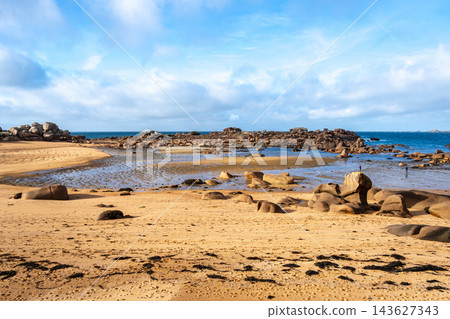 Sandy bay with granite reefs and tidal pools in Tregastel, France Sandy bay with granite reefs and tidal pools in Tregastel, France 143627343