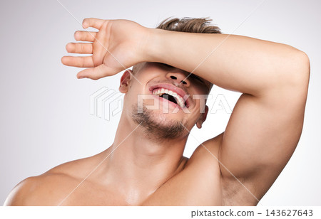 Studio, man and hand on face for skincare, wellness and cosmetics for beauty with laugh. White background, male model and shy with facial covering, skin glow and feeling fresh while topless with joy Studio, man and hand on face for skincare, wellness and cosmetics for beauty with laugh. White background, male model and shy with facial covering, skin glow and feeling fresh while topless with joy 143627643