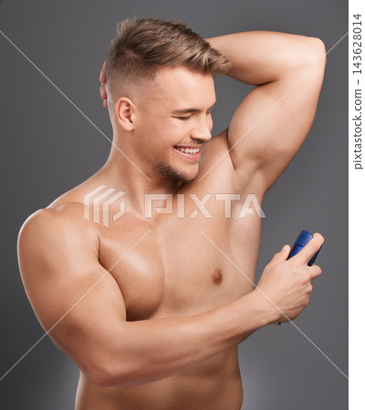 Happy man, deodorant and armpit with spray for health, cleaning and wellness or body care. Male person, skincare and hygiene in bathroom for routine, cosmetics and perfume by studio background Happy man, deodorant and armpit with spray for health, cleaning and wellness or body care. Male person, skincare and hygiene in bathroom for routine, cosmetics and perfume by studio background 143628014