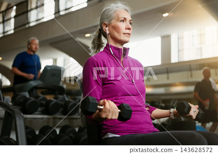 Dumbbell, health and music with mature woman on bench in gym for physical training or workout. Exercise, fitness and wellness with confident athlete person in performance club for active challenge 143628572