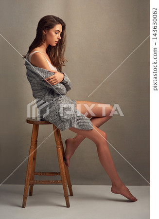 Woman, sitting and thinking of young model seated on stool in studio. Autumn fashion, idea and choice of student feeling relax, calm and contemplating on chair isolated by grey wall background Woman, sitting and thinking of young model seated on stool in studio. Autumn fashion, idea and choice of student feeling relax, calm and contemplating on chair isolated by grey wall background 143630062
