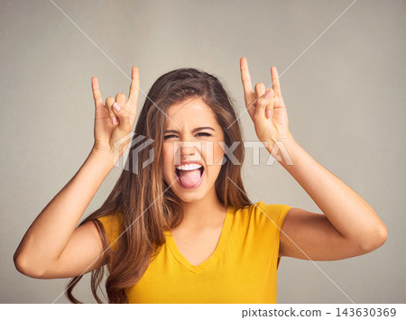 Woman, portrait and devil horns with hands in studio for grunge sign, tongue out or rock gesture on white background. Crazy, aesthetic and edgy female model for emoji, punk icon or rebel symbol Woman, portrait and devil horns with hands in studio for grunge sign, tongue out or rock gesture on white background. Crazy, aesthetic and edgy female model for emoji, punk icon or rebel symbol 143630369
