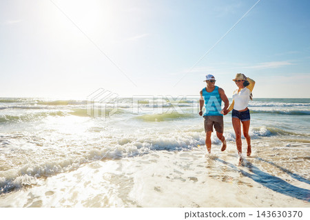 Walking, holding hands and couple by shore on beach for adventure, holiday and bonding by mockup. Outdoor, ocean and playful people for romance, boyfriend and girlfriend for vacation in California Walking, holding hands and couple by shore on beach for adventure, holiday and bonding by mockup. Outdoor, ocean and playful people for romance, boyfriend and girlfriend for vacation in California 143630370
