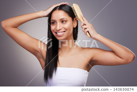 Hair care, thinking and woman in studio with brush for grooming, scalp treatment or keratin on gray background. Hairstyle, beauty and hands of model for satisfaction, cosmetics or collagen shine Hair care, thinking and woman in studio with brush for grooming, scalp treatment or keratin on gray background. Hairstyle, beauty and hands of model for satisfaction, cosmetics or collagen shine 143630874