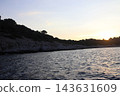 Sunset Over Rocky Island in Adriatic Sea near Cavtat Croatia with Seagulls Flying 143631609