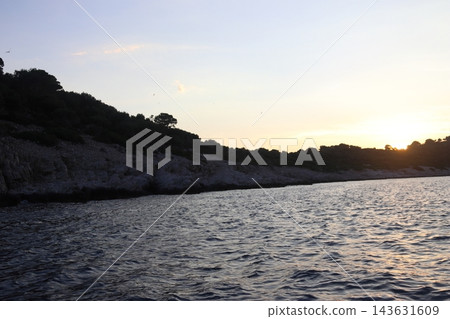 Sunset Over Rocky Island in Adriatic Sea near Cavtat Croatia with Seagulls Flying Sunset Over Rocky Island in Adriatic Sea near Cavtat Croatia with Seagulls Flying 143631609