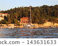 Villa Banac at Sunset on Cavtat Coast with Catamaran Anchored in Adriatic Bay, Croatia 143631633