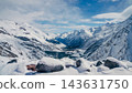 Mount Elbrus region winter panorama with snow-covered rocks, steep alpine slopes, and glacial valley under blue sky 143631750