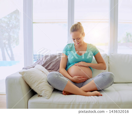 Relaxing, smile and pregnant woman on sofa in home holding belly for maternity care with happiness. Love, rest and maternal female person with stomach from Australia in living room at apartment. Relaxing, smile and pregnant woman on sofa in home holding belly for maternity care with happiness. Love, rest and maternal female person with stomach from Australia in living room at apartment. 143632016