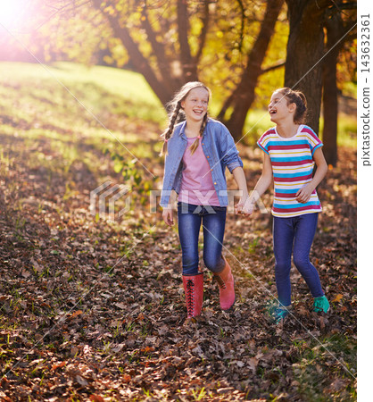 Holding hands, smile or children of friends in nature walking on adventure together in Autumn. Happy, fun or girl kids exploring in outdoor park, field or garden for bonding on weekend trip in Canada Holding hands, smile or children of friends in nature walking on adventure together in Autumn. Happy, fun or girl kids exploring in outdoor park, field or garden for bonding on weekend trip in Canada 143632361