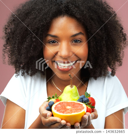 Black woman, studio and portrait with smile and fruit for fresh nutrition, pure for natural beauty. Female model, pink background or happy for cosmetics with sustainability, vegan makeup for wellness Black woman, studio and portrait with smile and fruit for fresh nutrition, pure for natural beauty. Female model, pink background or happy for cosmetics with sustainability, vegan makeup for wellness 143632665