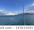 Enjoy winter fishing in the sea at Otaru Port and the scenery of blue skies. 143632685