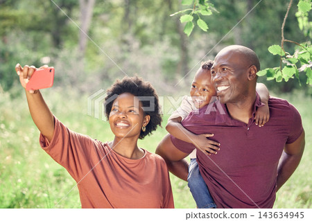 Selfie, black family and smile in nature with child, picture and memory for social media, travel and holiday. Vacation, woman and man with happiness, photography and piggyback of kid with parents Selfie, black family and smile in nature with child, picture and memory for social media, travel and holiday. Vacation, woman and man with happiness, photography and piggyback of kid with parents 143634945