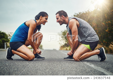 Fitness, runner couple and tying shoes in road for cardio, workout, endurance training or marathon. Wellness, sneakers and athlete man with woman getting ready for running, sports or morning exercise Fitness, runner couple and tying shoes in road for cardio, workout, endurance training or marathon. Wellness, sneakers and athlete man with woman getting ready for running, sports or morning exercise 143637548
