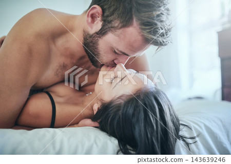 Couple, sex and kiss in bed for desire, body connection and intimate bonding in home. People, foreplay and lovers for passion or lust with touch on honeymoon, marriage and safety in naked romance Couple, sex and kiss in bed for desire, body connection and intimate bonding in home. People, foreplay and lovers for passion or lust with touch on honeymoon, marriage and safety in naked romance 143639246