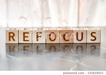 motivational word Refocus, from letters on wooden cubes motivational word Refocus, from letters on wooden cubes 143639815