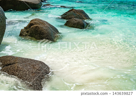 rocks in the sea with blue water rocks in the sea with blue water 143639827