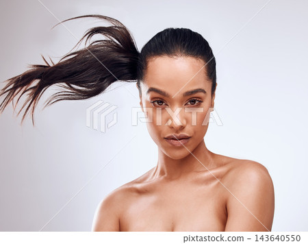 Haircare, portrait and woman in studio with cosmetics, keratin treatment and growth on gray background. Movement, female person and long hair with facial for luxury, wellness and aesthetic in salon Haircare, portrait and woman in studio with cosmetics, keratin treatment and growth on gray background. Movement, female person and long hair with facial for luxury, wellness and aesthetic in salon 143640550