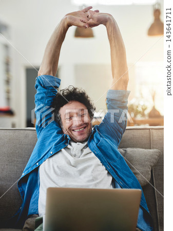 Stretching, relax and happy man on laptop in living room for freedom, finish or complete project in home. Peace of mind, computer and person on sofa for calm or freelancer resting on break in house Stretching, relax and happy man on laptop in living room for freedom, finish or complete project in home. Peace of mind, computer and person on sofa for calm or freelancer resting on break in house 143641711