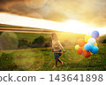 Nature, girl or child with balloons for walking, running and playing on grass field with scenic view. Australia, countryside and outdoor with kid with energy, inspiration and celebration in park 143641898