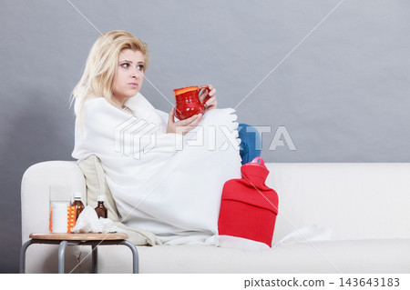 Woman being sick having flu lying on sofa Woman being sick having flu lying on sofa 143643183