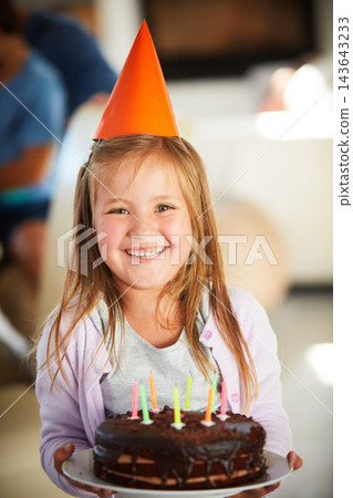 Happy, portrait and girl kid with birthday cake, smile and hat in classroom for event, party or celebration. Dessert, face and excited child with chocolate, candle or snack at school with friends Happy, portrait and girl kid with birthday cake, smile and hat in classroom for event, party or celebration. Dessert, face and excited child with chocolate, candle or snack at school with friends 143643233