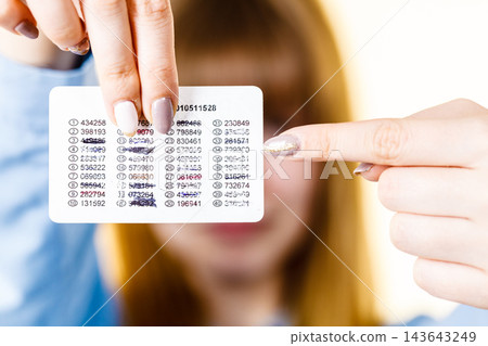 Woman holding codes for online transfers Woman holding codes for online transfers 143643249