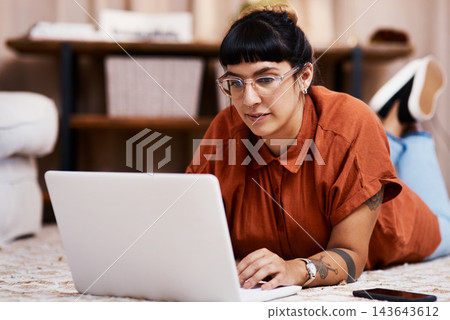 Carpet, internet and woman with laptop in home for streaming movie, subscription service and relax. Computer, watching and female person on floor with online video for social media post and chat app Carpet, internet and woman with laptop in home for streaming movie, subscription service and relax. Computer, watching and female person on floor with online video for social media post and chat app 143643612