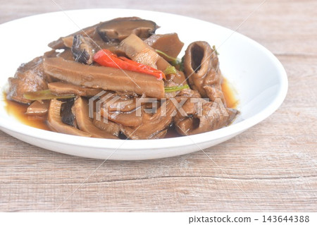 fried slice Chinese bamboo shoot with gluten and tofu couple black mushroom vegetarian food on plate  143644388