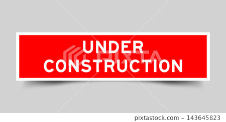 Red color square shape sticker label with word under construction on gray background Red color square shape sticker label with word under construction on gray background 143645823
