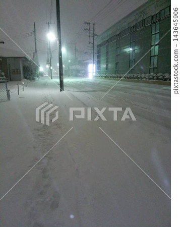 Roads at night covered in white snow and winter traffic conditions Roads at night covered in white snow and winter traffic conditions 143645906