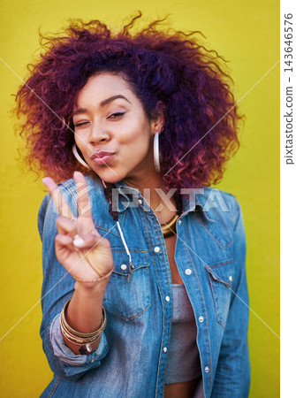 Studio, portrait and girl with wink, peace sign and isolated by yellow background. Fashion model, streetwear and jewelry with stylish outfit, v symbol and emoji with pout expression or personality Studio, portrait and girl with wink, peace sign and isolated by yellow background. Fashion model, streetwear and jewelry with stylish outfit, v symbol and emoji with pout expression or personality 143646576