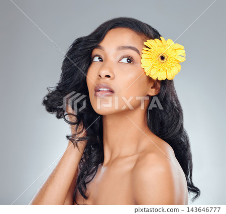 Woman, flower and thinking with natural beauty for texture or collagen on a white studio background. Face of female person, brunette or young model in wonder with glow, shine or bloom for treatment 143646777