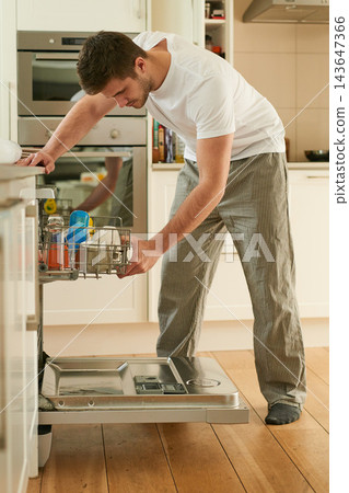 Man, kitchen and washing dishes with dishwasher for cleaning, hygiene and housekeeping. House chores, domestic work and maintenance in morning for germs, safety and dirty with technology on day off Man, kitchen and washing dishes with dishwasher for cleaning, hygiene and housekeeping. House chores, domestic work and maintenance in morning for germs, safety and dirty with technology on day off 143647366
