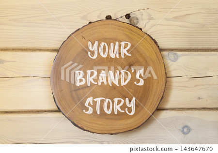 Branding and your brands story symbol. Concept words Your brands story on beautiful wooden circle. Beautiful wooden wall background. Business branding your brands story concept. Copy space. Branding and your brands story symbol. Concept words Your brands story on beautiful wooden circle. Beautiful wooden wall background. Business branding your brands story concept. Copy space. 143647670