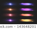 Abstract bright light sources creating horizontal lines and circular lens flares on dark background 143648201