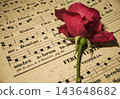 A single red rose placed on an old neumatic score. 143648682