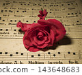 Antique sheet music and vibrant red roses 143648683