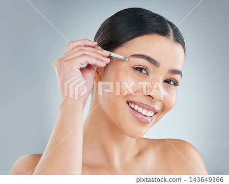 Portrait, woman and tweezers for eyebrow in studio for grooming, self care or hair removal routine. Smile, cosmetic and female person with epilation tool for plucking face isolated by gray background Portrait, woman and tweezers for eyebrow in studio for grooming, self care or hair removal routine. Smile, cosmetic and female person with epilation tool for plucking face isolated by gray background 143649366