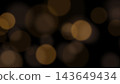 Amber bokeh and flare floating against a black background (16:9) 143649434