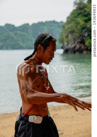 Local man engaging in conversation on tropical beach Local man engaging in conversation on tropical beach 143649933