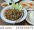 Authentic Thai basil stir-fry with fried egg and rice, delicious Thai food, appetizing food photography. 143650479